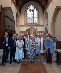 Group of people standing in front of the altar in St James Church in Wellane